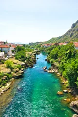 Mostar, Bosnia and Herzegovina - APRIL 20, 2024: Historical Mostar Bridge or Stari Most in Mostar Old Town. On a hot, sunny, spring afternoon.