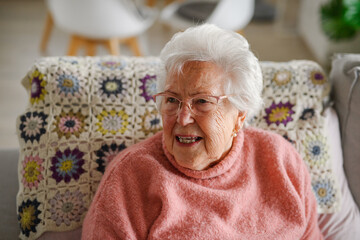 Portrait of elderly woman at home, having relaxing moment.