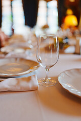 An empty wine glass on a table served for a banquet. 