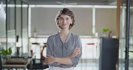 Young adult gen z cute girl agent boss standing proud fold hand look cam indoor job office work place happy french woman lady worker expert staff in formal dress cross arms do pose head shot video day