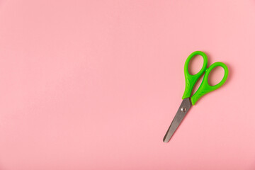 Bright children's scissors on a colored paper background. Stationery. Goods for school. Place for...