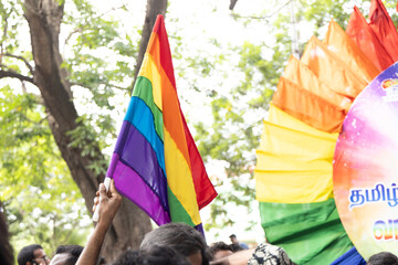Chennai, Tamilnadu India - June 25 2023 : Rear view of Group of people with pride rainbow flag and banners in the pride parade.