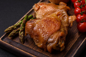 Delicious juicy chicken thighs baked on the grill with salt