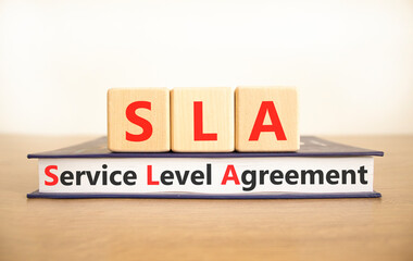 SLA service level agreement symbol. Concept words SLA service level agreement on beautiful wooden...