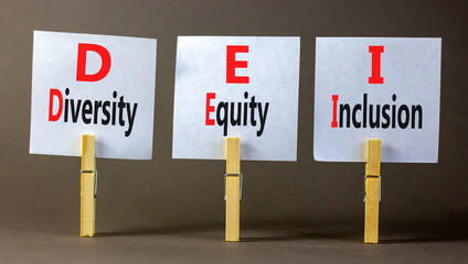 DEI diversity equity and inclusion symbol. Concept words DEI diversity equity inclusion on beautiful paper. Beautiful grey background. Business DEI diversity equity and inclusion concept. Copy space