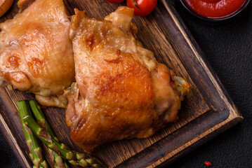 Delicious juicy chicken thighs baked on the grill with salt