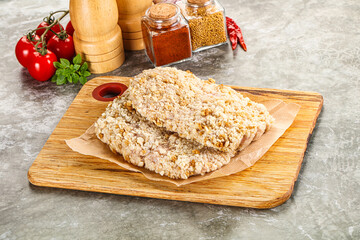 Breaded raw breaded meat schnitzel