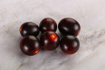 Raw ripe black kumato tomato