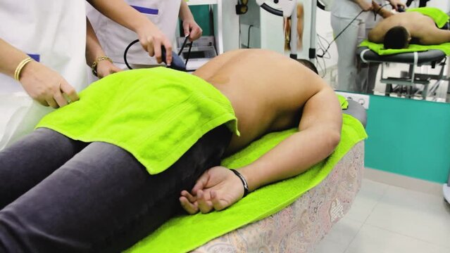 Footage of an ultrasound therapy due to a back injury