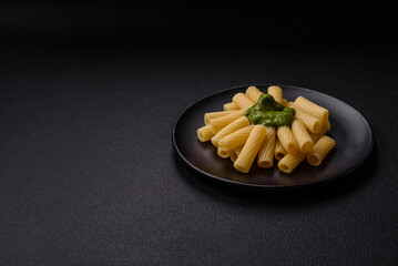 Delicious pasta with spinach sauce, olive oil and parmesan cheese