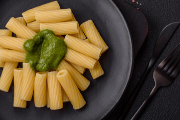 Delicious pasta with spinach sauce, olive oil and parmesan cheese
