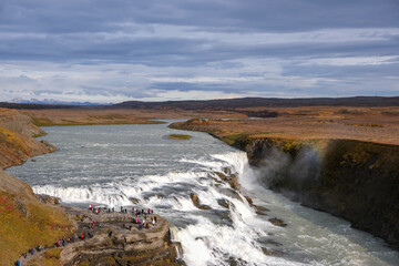 Panoramic view on Gullfoss waterfall on the Hvíta river, a popular tourist attraction and part of the Golden Circle Tourist Route in Southwest Iceland. Golden Waterfall.