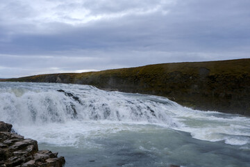Panoramic view on Gullfoss waterfall on the Hvíta river, a popular tourist attraction and part of the Golden Circle Tourist Route in Southwest Iceland. Golden Waterfall.