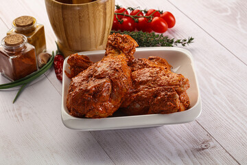 Raw turkey shoulder wing in Indian tandoori marinade