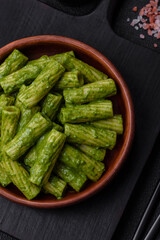 Delicious pasta with spinach sauce, olive oil and parmesan cheese
