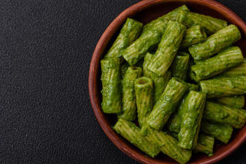 Delicious pasta with spinach sauce, olive oil and parmesan cheese