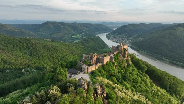 Drone view of Beautiful landscape with Aggstein castle ruin and Danube river at sunset in Wachau, Austria