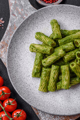 Delicious pasta with spinach sauce, olive oil and parmesan cheese