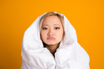 Photo of upset pretty cute woman wrapped warm blanket want sleep isolated on yellow color background