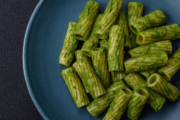 Delicious pasta with spinach sauce, olive oil and parmesan cheese