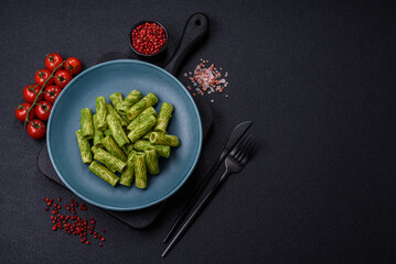 Delicious pasta with spinach sauce, olive oil and parmesan cheese