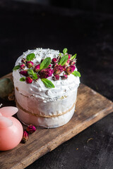 Easter cake with Swiss meringue and  flowers. Easter eggs