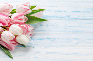 Pastel colorful tulips grace the table, providing a serene and vibrant backdrop