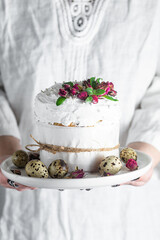 Easter cake with Swiss meringue and  flowers. Easter eggs