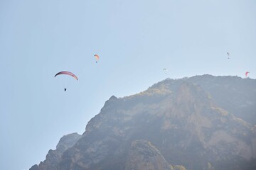 The sport of paragliding. Parachuting over high mountains. Beautiful natural landscape.