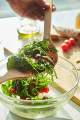 The final result of cooking a salad of greens and fried garlic, cherry tomatoes and Chorizo sausage. The cooking process, step-by-step recipe