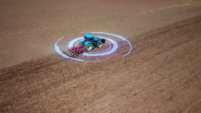 Autonomous driverless tractor of the future, controlled by artificial intelligence, plows the soil. View from drone, tracking GPS system, HUD elements. Digital futuristic technologies in agriculture. 