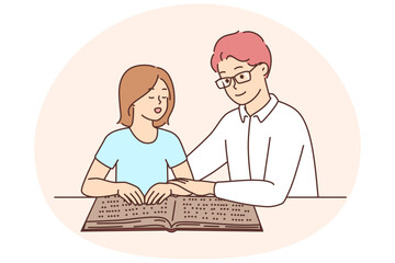 Male tutor teach child reading braille