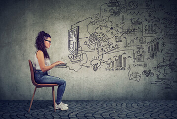 Hipster young business woman working in an office on computer