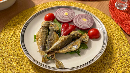 Fried fish and salad ready to be served on a plate