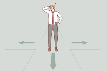 Thoughtful business man makes choice standing at crossroads and accepts difficult decision on choosing path. Guy entrepreneur is thinking about strategic decision to develop own company.