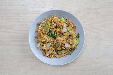 A plate of fried rice with pork.
