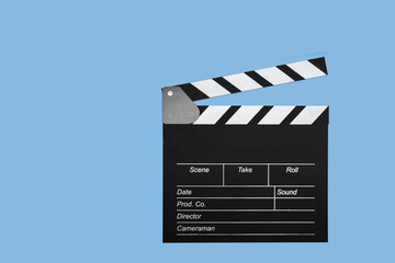 Cinema clapperboard on a blue background, copy space, television, media, shot.