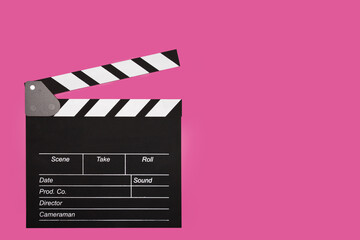 Cinema clapper board on a pink background, copy space, director's tool for setting scenes,equipment...