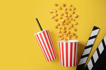 Popcorn sweet bucket with soda cup and Cinema clapper board, caramel pop corn in cup, video...