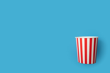 Popcorn box, cinema snack pack, theater film salty treat,blue background