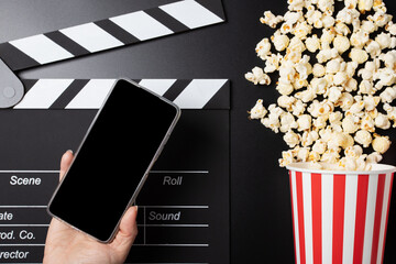 Cinema tickets online, Popcorn bucket and clapper board with phone, mobile cinema booking,...