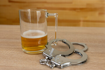 Handcuffs and a beer mug. Beer abuse concept.
