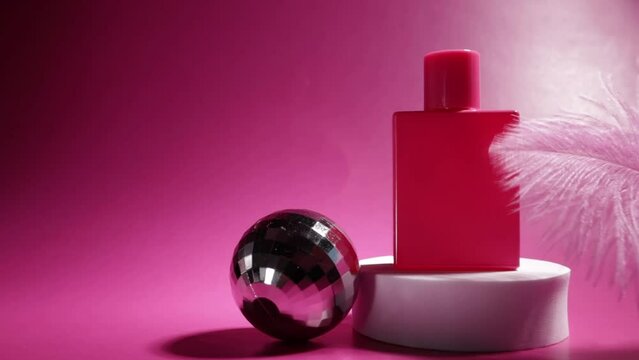 pink perfume on the podium with a swaying soft feather and party disko ball,purple essence, bright femininity, modern elegance