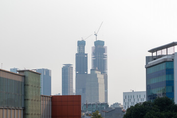 View of skyscraper construction in one corner of Jakarta. Construction site with a tower crane.