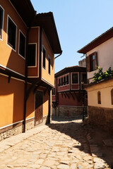 Beautiful cobble stone street between traditional houses in the old town of Plovdiv, Plowdiw, Bulgaria