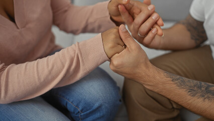 Interracial couple holding hands in a symbol of love and togetherness, showcasing diversity and...