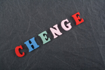 CHENGE word on black board background composed from colorful abc alphabet block wooden letters,...