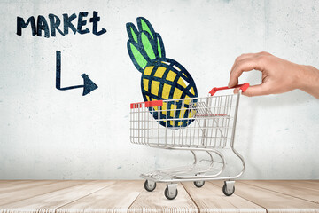 Shopping cart with globe drawing in a market