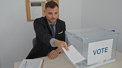 A businessman casting his ballot at a voting station indoors, ensuring his participation in the...