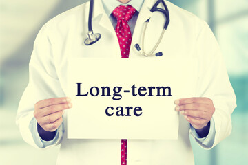 Closeup of a health care professional holding a sign long term care 